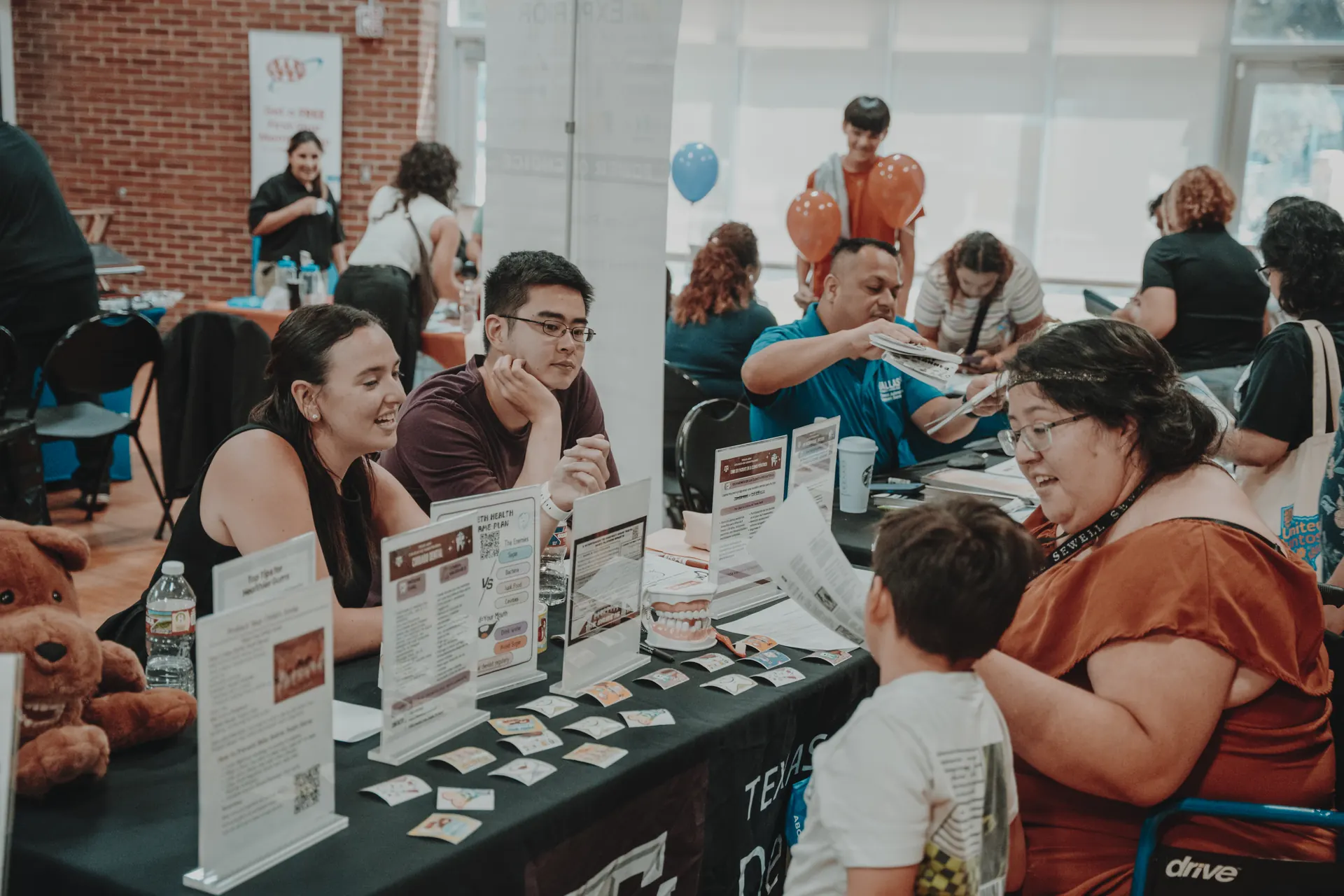 Families connecting with health resource partners at a resource fair